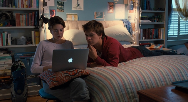 Wide shot frame from The Fault in Our Stars — sitting, book, room