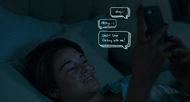 Wide shot frame from The Fault in Our Stars — bed, hand, face