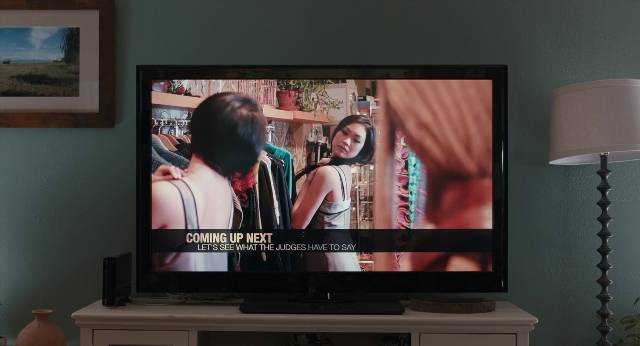 Wide shot frame from The Fault in Our Stars — standing, room, television