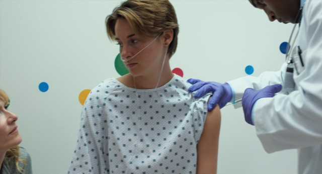 Wide shot frame from The Fault in Our Stars — sitting, bed, coat