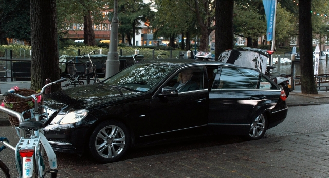 Wide shot frame from The Fault in Our Stars — street, car, bicycle