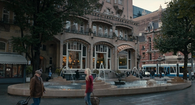 Wide shot frame from The Fault in Our Stars — walking, restaurant, fountain