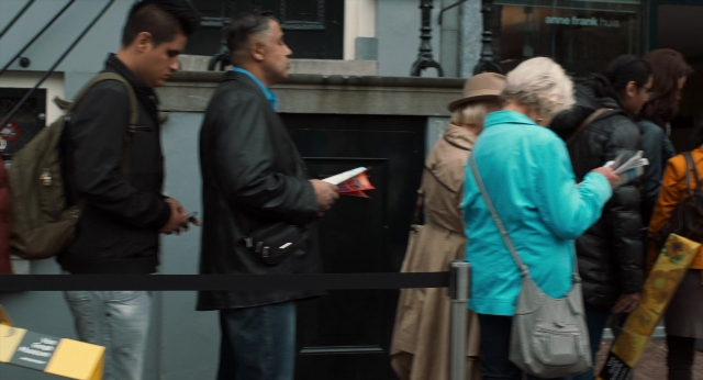 Wide shot frame from The Fault in Our Stars — book, standing, door