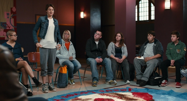 Wide shot frame from The Fault in Our Stars — sitting, standing, room