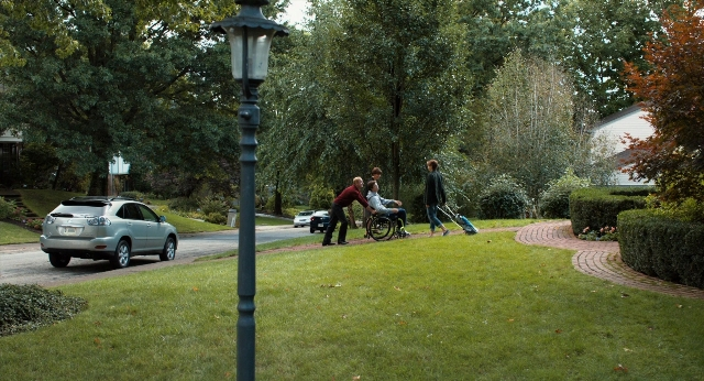 Wide shot frame from The Fault in Our Stars — walking, street, car
