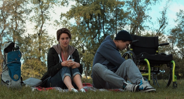 Wide shot frame from The Fault in Our Stars — sitting, hat, hand