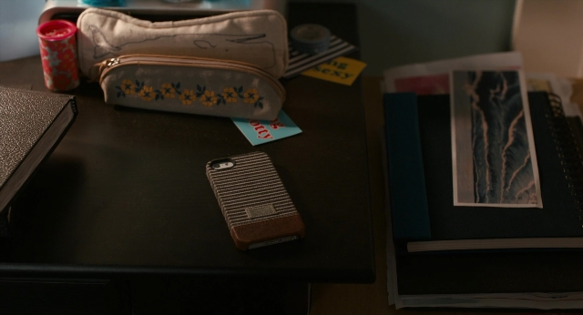 Wide shot frame from The Fault in Our Stars — book, table, phone