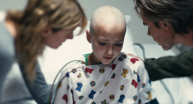 Medium shot frame from The Fault in Our Stars — standing, bed, shirt