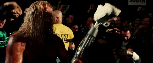 Wide shot frame from The Wrestler — standing, shirt, hair