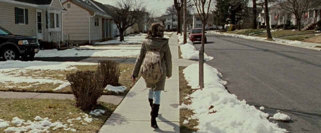 Wide shot frame from The Wrestler — walking, street, car
