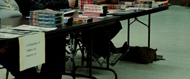 Frame from The Wrestler — sitting, book, room