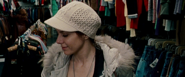 Wide shot frame from The Wrestler — standing, hat, face