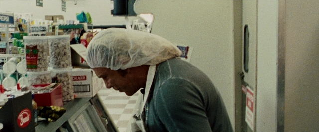 Wide shot frame from The Wrestler — hat, food, person