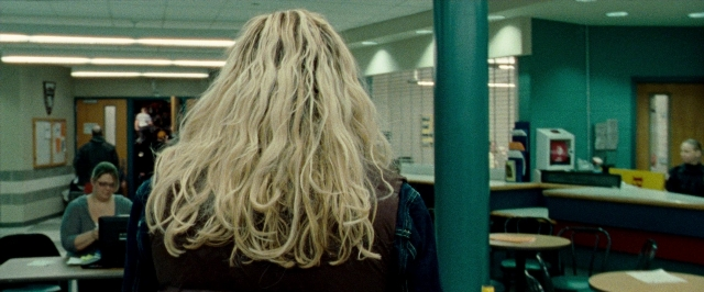 Wide shot frame from The Wrestler — sitting, standing, room