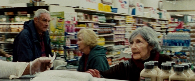 Wide shot frame from The Wrestler — standing, food, bag