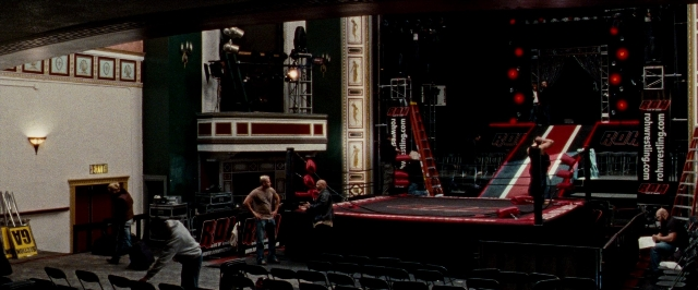 Wide shot frame from The Wrestler — sitting, standing, person