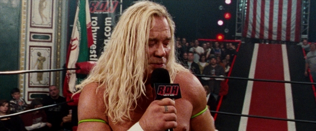 Wide shot frame from The Wrestler — microphone, face, hair