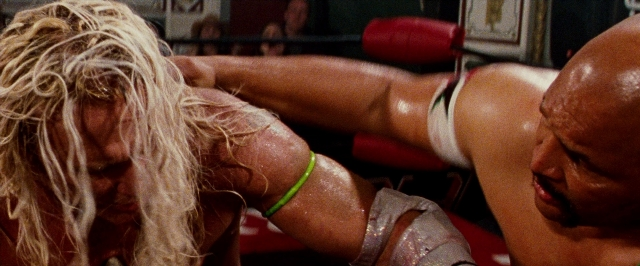 Wide shot frame from The Wrestler — bag, hair, fight