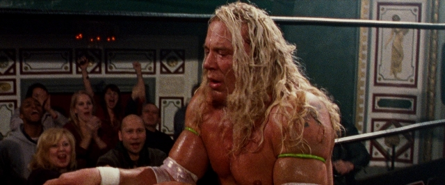 Wide shot frame from The Wrestler — standing, mirror, hair