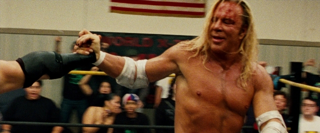 Wide shot frame from The Wrestler — flag, face, hair