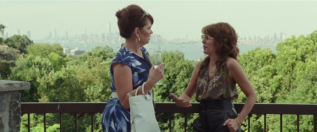 Wide shot frame from The King of Staten Island — standing, dialogue, hand
