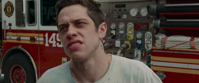 Medium shot frame from The King of Staten Island — fire, shirt, face