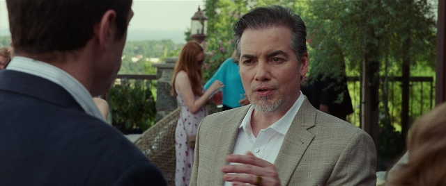 Medium shot frame from The King of Staten Island — standing, dialogue, suit