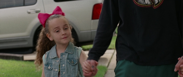 Wide shot frame from The King of Staten Island — standing, walking, street