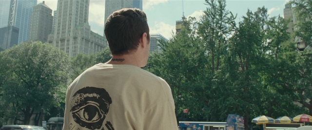 Wide shot frame from The King of Staten Island — standing, car, shirt