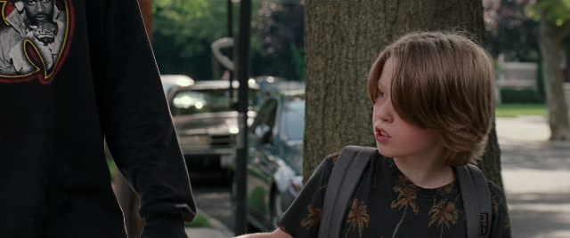 Wide shot frame from The King of Staten Island — standing, walking, street