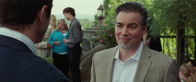 Medium shot frame from The King of Staten Island — standing, dialogue, suit