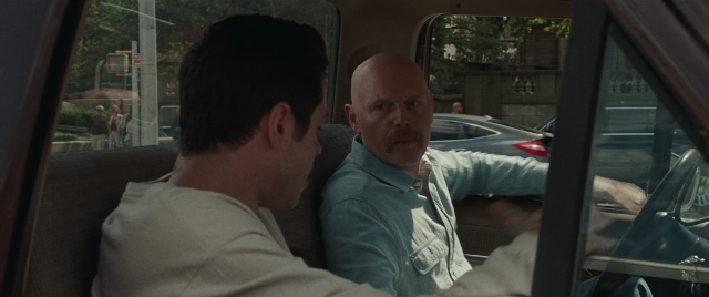 Wide shot frame from The King of Staten Island — sitting, dialogue, street