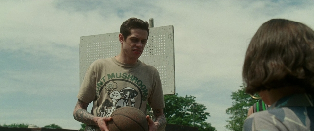 Wide shot frame from The King of Staten Island — standing, dialogue, shirt