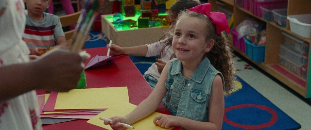 Wide shot frame from The King of Staten Island — sitting, room, table