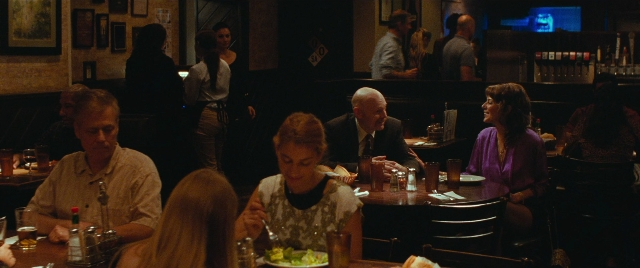Wide shot frame from The King of Staten Island — sitting, table, dialogue