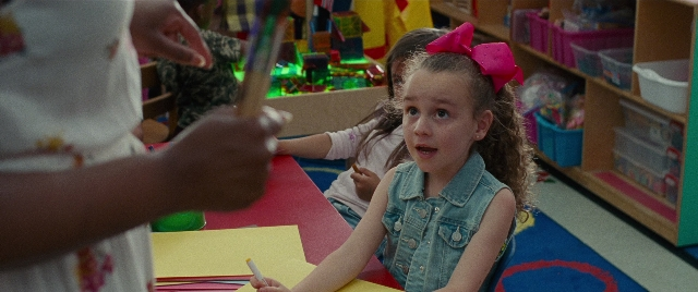 Wide shot frame from The King of Staten Island — sitting, table, hand