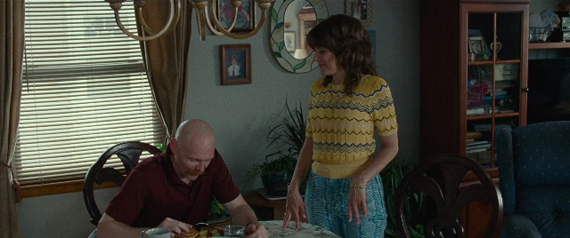 Wide shot frame from The King of Staten Island — sitting, standing, plate