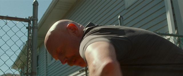 Wide shot frame from The King of Staten Island — shirt, person, human face