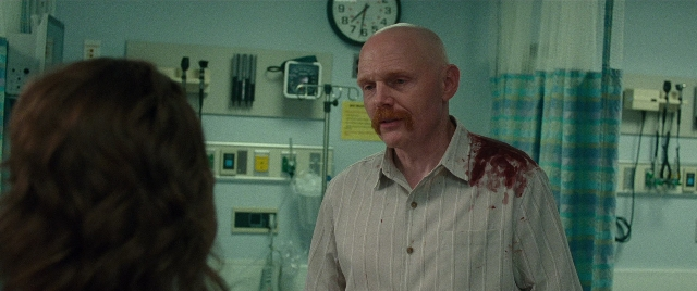 Wide shot frame from The King of Staten Island — standing, room, shirt