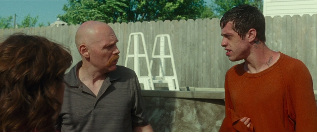 Wide shot frame from The King of Staten Island — standing, dialogue, shirt