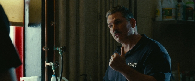 Wide shot frame from The King of Staten Island — standing, kitchen, shirt