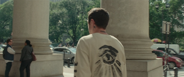 Wide shot frame from The King of Staten Island — standing, walking, street