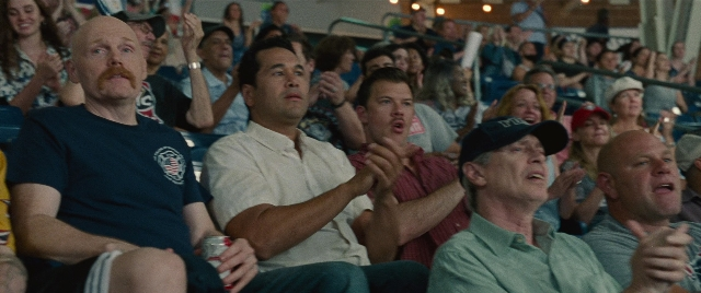 Wide shot frame from The King of Staten Island — sitting, room, shirt