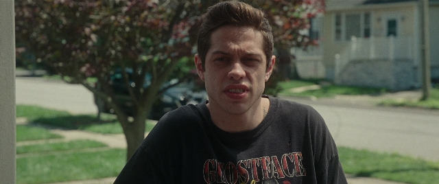 Medium shot frame from The King of Staten Island — standing, street, shirt