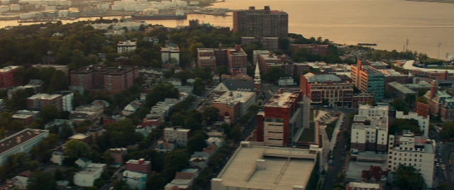 Wide shot frame from The King of Staten Island — water, tower, skyscraper