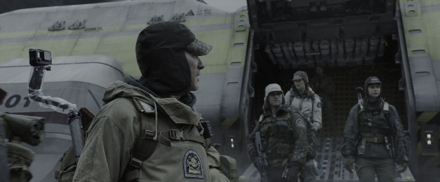 Wide shot frame from Alien: Covenant — standing, hat, gun
