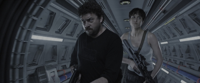 Wide shot frame from Alien: Covenant — standing, shirt, gun
