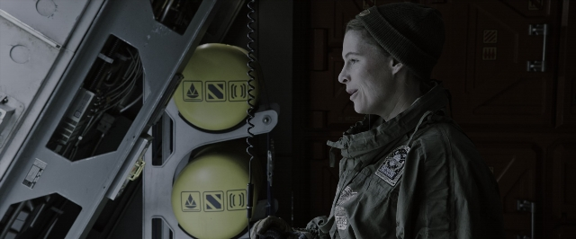 Wide shot frame from Alien: Covenant — standing, room, door