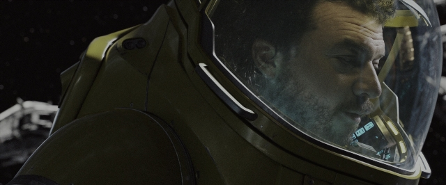 Wide shot frame from Alien: Covenant — hat, suit, face
