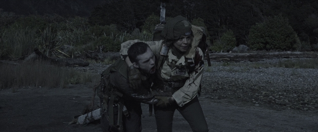 Wide shot frame from Alien: Covenant — standing, hat, gun